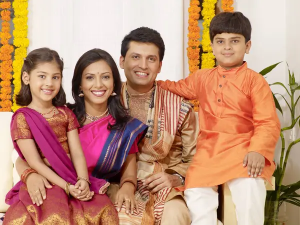 stock image Parents with children in traditional wearing sitting in house 