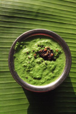 Green Chutneys made from pudina served in bowl on banana leaf clipart