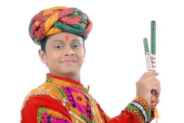 Rajasthani man playing dandiya on white background clipart