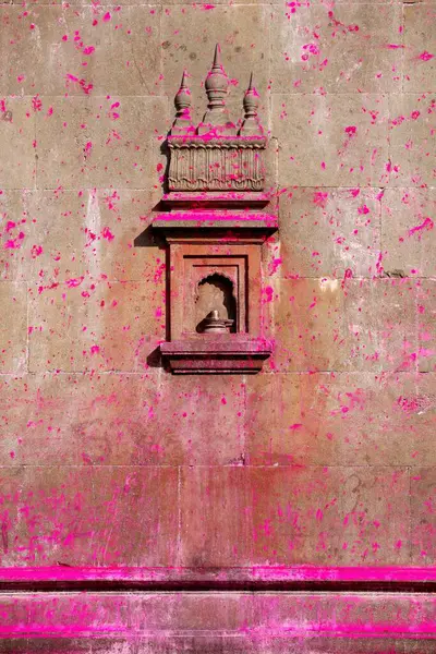 stock image Art work on wall of Jotiba temple immersed in gulal bright shades of pink powder Kolhapur city, Village Wadi, Ratnagiri, Maharashtra, India 