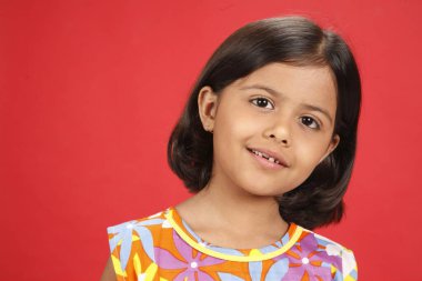 Sekiz yaşında kız, başını hafifçe sola eğmiş.