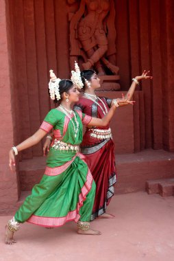 Women performing classical traditional Odissi dance  clipart