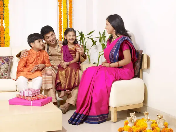 stock image Parents with children in traditional wearing sitting in house 