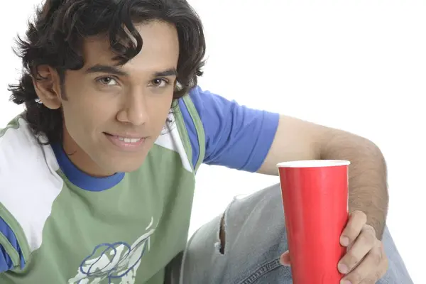 stock image Teenage boy holding glass of soft drink and smiling MR 687T