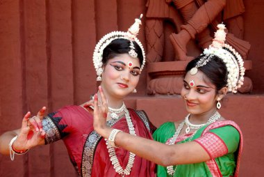 Women performing classical traditional Odissi dance  clipart