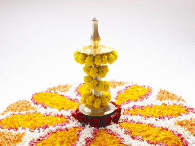 Onam Kerala festival, Diya with flowers isolated on white background clipart