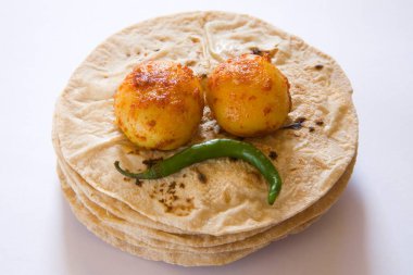 Indian cuisine roti chapatti with green chilli and tandoori masala aloo potato served , India clipart