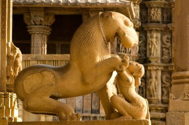 Sculpture of lion omnipresence of shardul underscores mythic origins of chandella dynasty Jagadambi temple at Khajuraho , Madhya Pradesh , India clipart