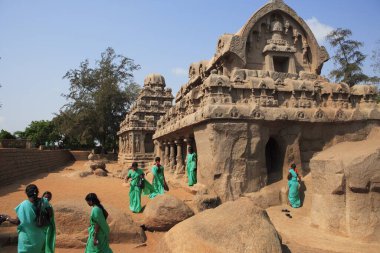 College girls with green sarees at Pancha Rathas carved during the reign of King Mamalla (Narasimhavarman I; c. 630 - 670) Monolith rock carving temples ; Mahabalipuram ; District Chengalpattu ; Tamil Nadu ; India UNESCO World Heritage Site clipart