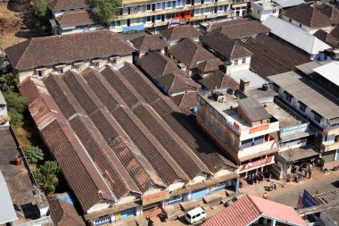 View from top floor of 260 feet high Bible tower new construction seen roof made with tiles prominent ; Thrissur ; Kerala ; India clipart