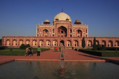 Tourists at Humayun's tomb built in 1570 made from red sandstone and white marble first garden-tomb on Indian subcontinent persian influence in mughal architecture, Delhi, India UNESCO World Heritage Site   clipart