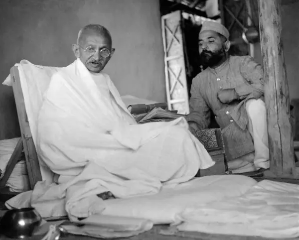 stock image Mahatma Gandhi in his hut at Sevagram Ashram, Vardha, Maharashtra, India, together with co-worker Dr. Zakir Hussain, 1945  