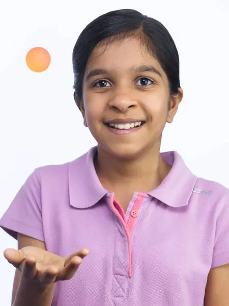 stock image Young girl tossing Ball in the Air 