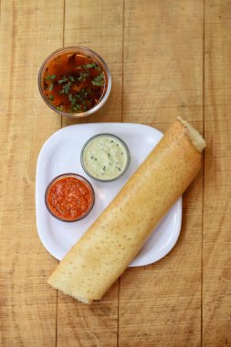 Masala dosa , South Indian meal served with sambhar and coconut chutney over, Traditional South Indian rice Dosa. Delicious foreign meal  clipart