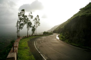 Panchgani ve Wai tepelerini birbirine bağlayan Pasarani ghat virajlı yolunda rüzgarlı muson manzarası; Maharashtra; Hindistan