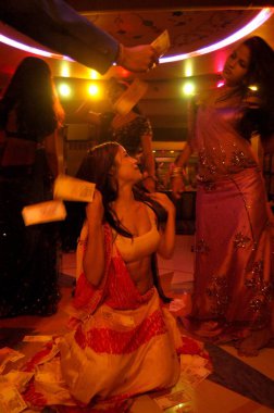 Money showering on decked up girls dancing in bar, Bombay Mumbai, Maharashtra, India  clipart