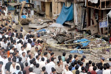 Policemen  inspecting bomb blast site crowd gathered to see at Zaveri Bazaar in busy Kalbadevi area, Bombay Mumbai, Maharashtra, India August 26th 2003  clipart