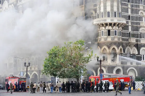 stock image Fire Brigade trying to extinguish the fire in old wing of Taj Mahal hotel ; after terrorist attack by Deccan Mujahedeen on 26th November 2008 in Bombay Mumbai ; Maharashtra ; India