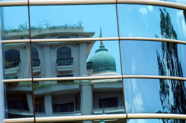 stock image Reflection of a building on RMZ Corp, RMZ Titanium building a modern architecture with steel girders on it in Bangalore city, Karnataka, India 