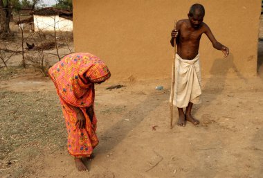 People standing outside hut, Garwa and Latehar, Jharkhand, India  clipart