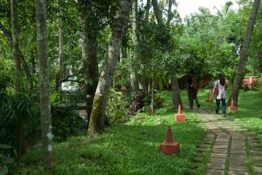 Couple walking on path in heritage lake resort   clipart