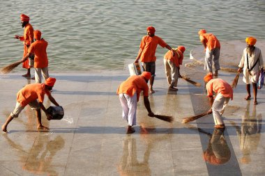 Karsevaks cleaning the Ghat for celebration of 300th year of consecration of perpetual Guru Granth Sahib, Sachkhand Saheb Gurudwara in Nanded, Maharashtra, India  clipart