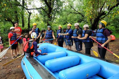 people listening to safety instructions before river Rafting, Raigad, Maharashtra, India, Asia  clipart