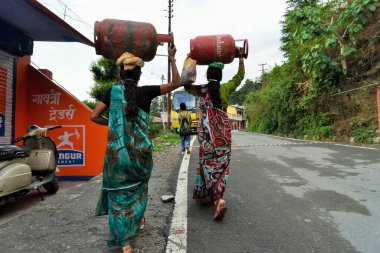 Women carrying LPG cylinders, Deodars Guest House, Papersali, Almora, Uttarakhand, India, Asia clipart