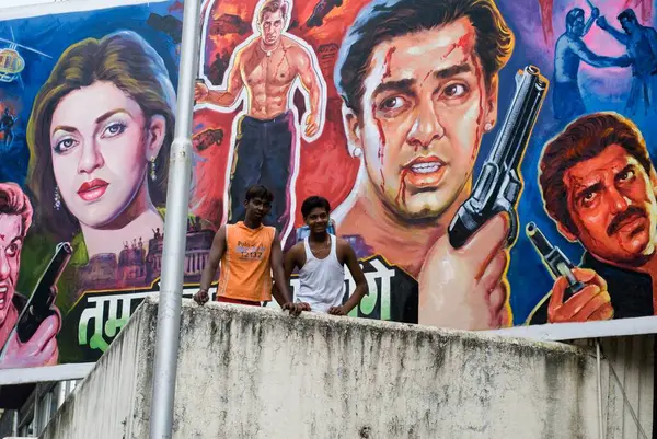 stock image Two Boys standing and Hindi Film Poster in Background , Mumbai Bombay, Maharashtra, India 