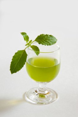 Kutsal Basil bitkisi Tulsi yaprakları ve bir bardak meyve suyu. 