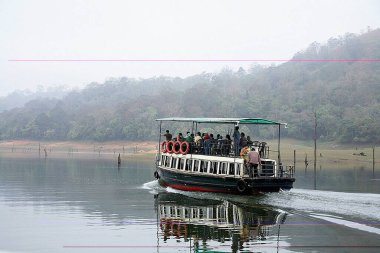 Early morning tourists on boat ride at Periyar lake, Periyar wildlife sanctuary, Thekkady, Kerala, India  clipart