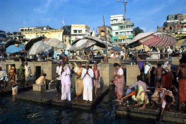 Varanasi Uttar Pradesh Hindistan 'ın ghat basamaklarında ayin duaları yapıyor. 