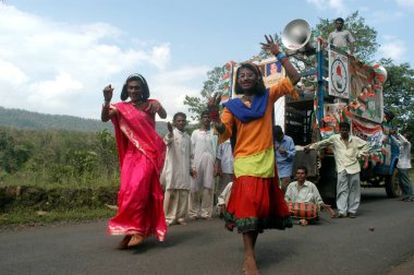Eunuchs dancing to tune of the music being played by the campaigning party of Congress party candidate during the 2004 Lok Sabha elections near Melghat in Nagpur, Maharashtra, India  clipart