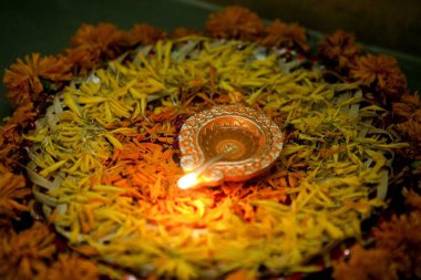 Earthen oil lamp with flower petals decoration diwali festival Mumbai Maharashtra India Asia clipart