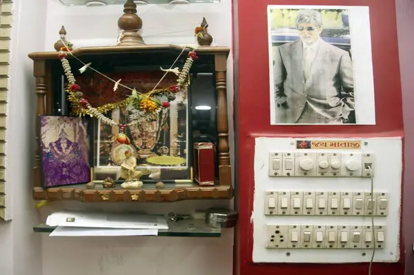 Stock image Corner for worship, in barber shop with photo of Indian film superstar Amitabh Bachchan, idol, Hinduism, Religion, Bombay Mumbai, Maharashtra, India 