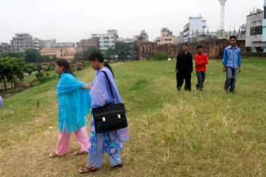 Tourists Walking on Lawn of Lalbagh fort built by prince Muhammad Azam, Son of Mughal Emperor Aurangzeb in 1678 AD, Dhaka, Bangladesh  clipart