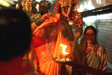 Eunuch covering his head during prayers of goddess Yellama during wedding of eunuchs on occasion of Bewa Purnima at Ghatkopar ; Bombay now Mumbai ; Maharashtra ; India clipart