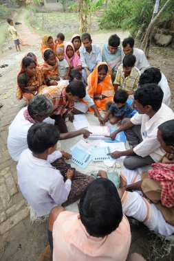 Party workers explaining voters at Dongajora village bengal calcutta India Asia  clipart