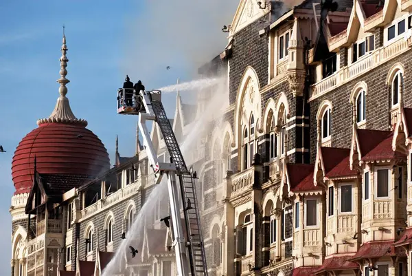 stock image Fire fighters try to douse fire of Taj Mahal hotel after terrorist attack by deccan mujahedeen on 26th November 2008 in Bombay Mumbai, Maharashtra, India 