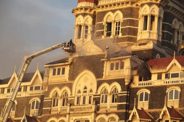Smoke emits from Taj Mahal Hotel during terrorist attack by Deccan Mujahideen ; Bombay Mumbai ; Maharashtra ; India 27-November-2008 clipart