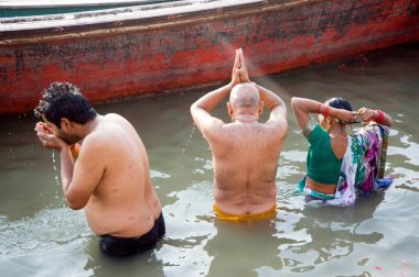 pilgrims bathing at ganga ghat varanasi uttar pradesh India Asia  clipart