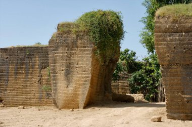 Gateway to discarded stone quarry at Madhavpur Ghed, Porbandar, Gujarat, India clipart