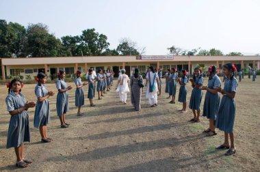 School girls welcoming guests at Shivkar village, Panvel taluka, Maharashtra, India 