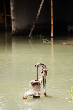 Hand pump in the water ; Kosi river flood in year 2008 ; Purniya district ; Bihar ; India clipart