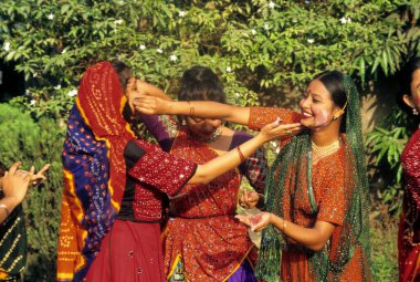 women playing with paint in holi festival , india , clipart