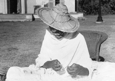 Mahatma Gandhi wearing a Noakhali hat whilst spinning at Birla House, New Delhi, India, November 1947    clipart