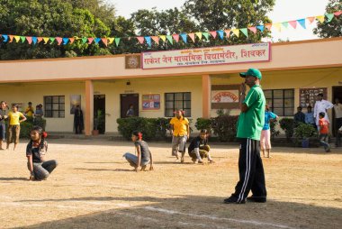 School children playing game of Kho Kho at Shivkar Village, Panvel taluka, Maharashtra, India 
