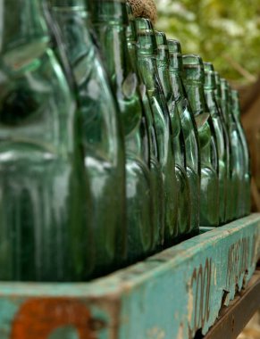 Antique soda bottles on table clipart