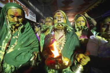 Eunuch followers with tugged neem leaves praying before goddess Yellama ; wedding of eunuchs on occasion of Bewa Purnima at Ghatkopar ; Bombay now Mumbai ; Maharashtra ; India clipart