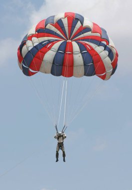 Gökyüzünde paraşütle uçan maceraperest kişi.